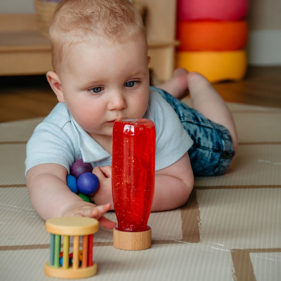 Petit Boum sensory bottle sensorische fles met glitters, pailletten en pompons in de kleur rood