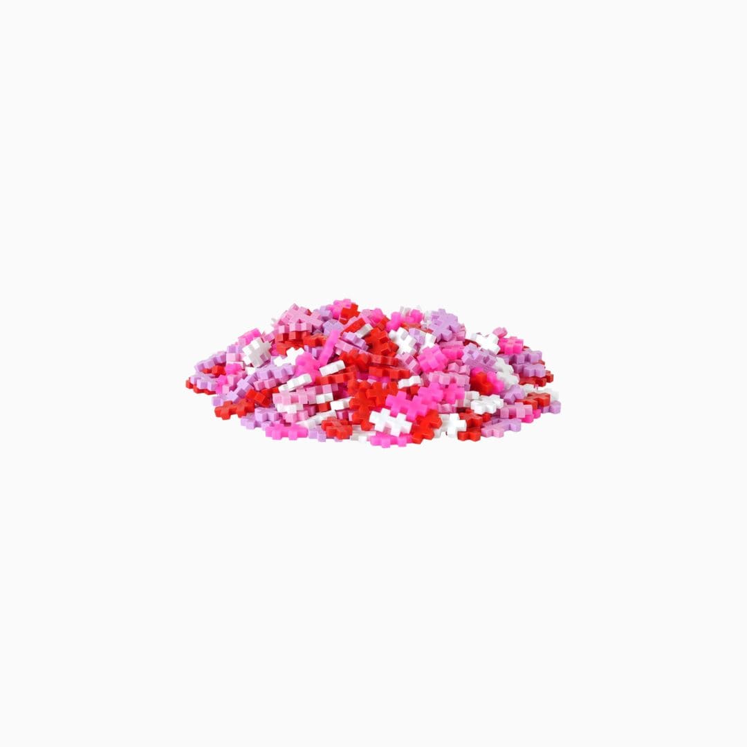 PlusPlus tube met constructie speelgoed in  de kleuren roze, rood en wit
